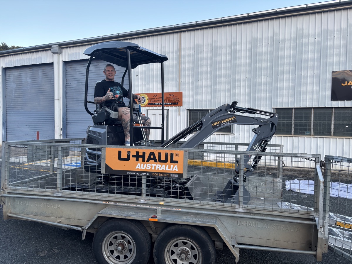 Zac seated in the cab of his new JHM18 on a trailer